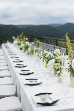 Modern elegant wedding decorated table on blurred mountain hill
