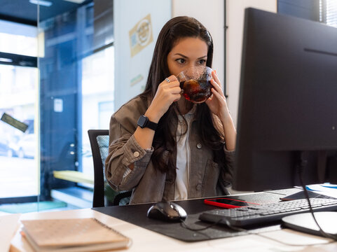 Woman drinking tea at work 