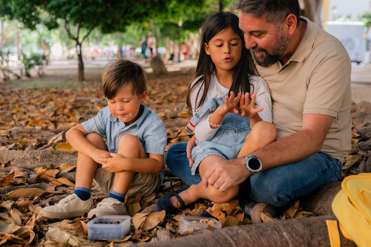 Dad spending time with his kids at park 