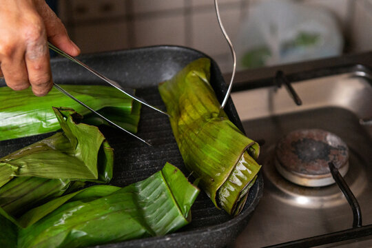Nasi bakar or roasted rice cooking with banana leaves as the wrappers