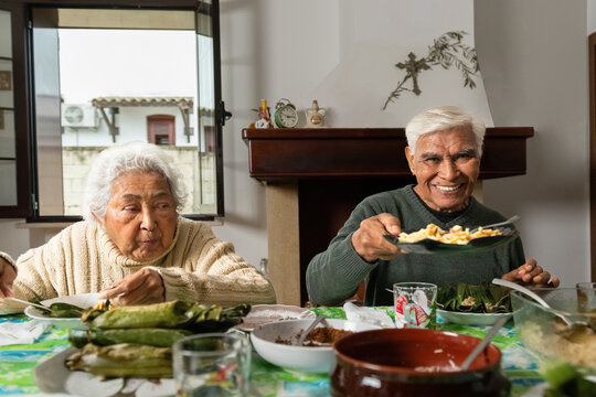 Elderly couple sharing a traditional Indonesian meal at home