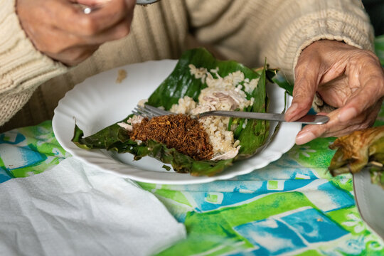 Person Enjoying Traditional Indonesian Roasted Rice and Spicy Coconut 