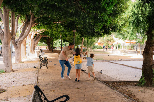 Father entertaining kids in park