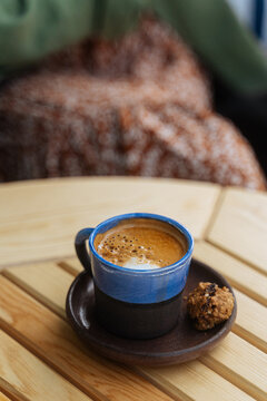 Coffee in ceramic cup with cookie 