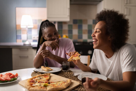 Diverse multiracial woman laughing at joke near friend