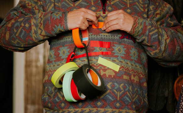 Colorful patterned sweater with adhesive tape rolls