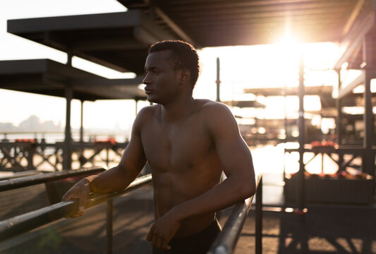 Sportive serious black man recovering after exercise