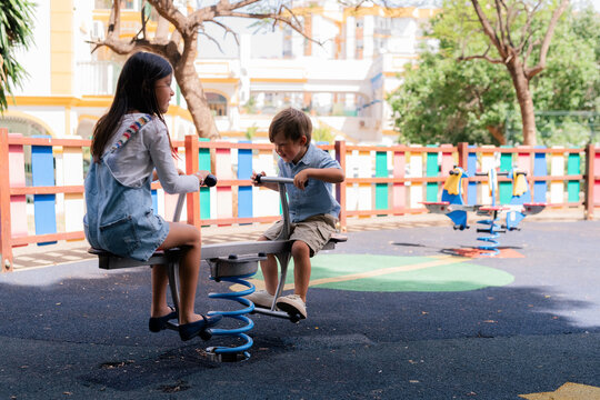 Kids riding on seesaw 
