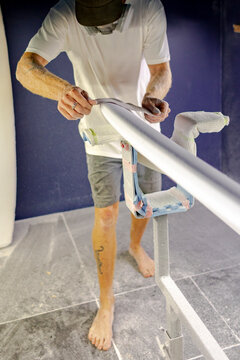 Craftsman finishing surfboard blank in Australia