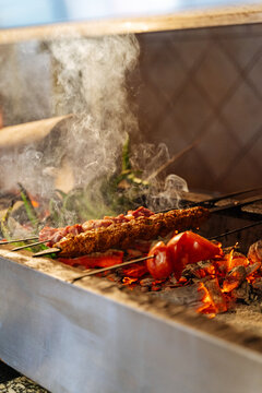 Mixed kebabs grilling over hot charcoal -