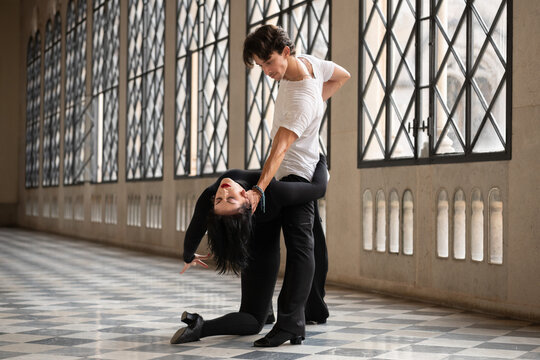 Man supporting flexible woman during dance