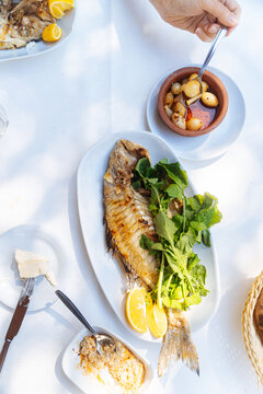 Grilled fish with greens and garlic appetizer