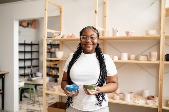 Student Holding Handmade Ceramic Bowls