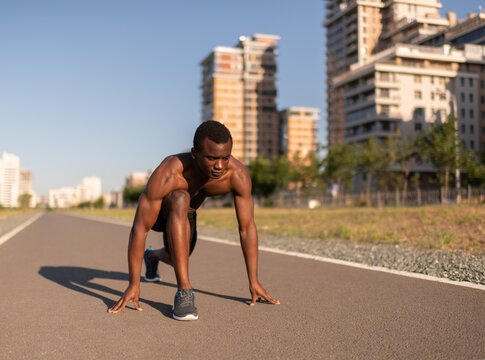 Black male athlete ready for sprinting on running track