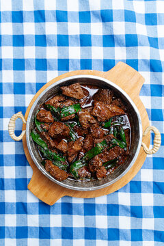 Cooked liver with herbs in metal pan