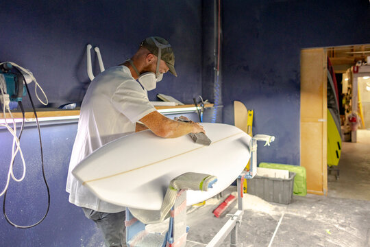 Surfboard shaper shaping board