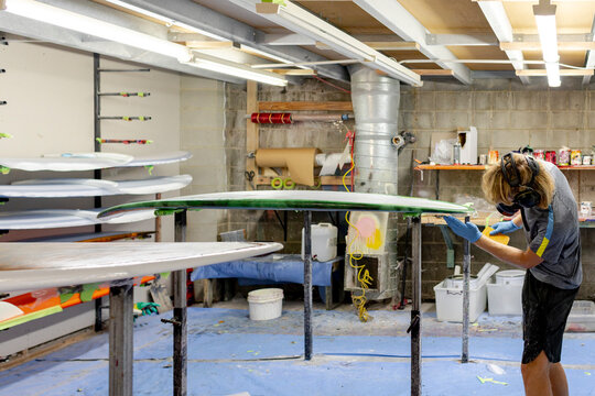 Shaper checking lap line in a glassing room in Australia