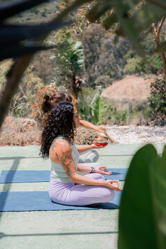 Women meditating in park 