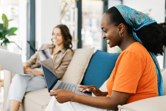 Women Working on Laptops in a Modern Workspace