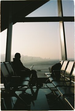 Travelers wait at an airport terminal during morning layover
