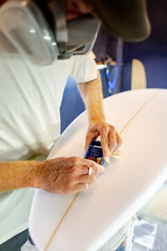 Surfboard shaper trimming stringer