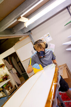 Shaper glassing surfboard in Australia