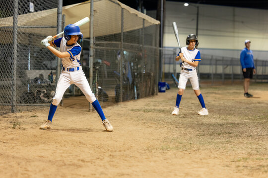 Young Baseball Team Trains at Night on the Diamond
