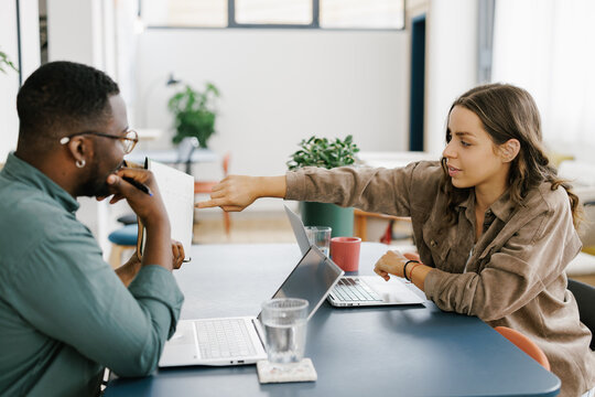 People Discussing Ideas in a Modern Workspace During Daytime