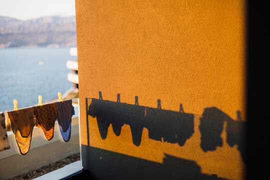 Drying laundry silhouette on orange wall