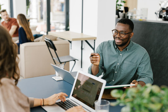 Meeting Between Two People in a Modern Office Cafe