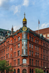 Obraz premium Historic Red Brick Corner Building with Gold Clock Tower in Washington DC