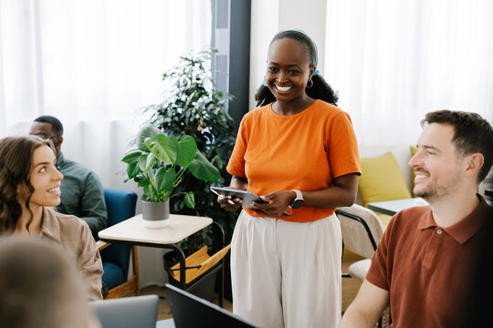 Group Meeting Takes Place in Office With Diverse Team Members Smiling