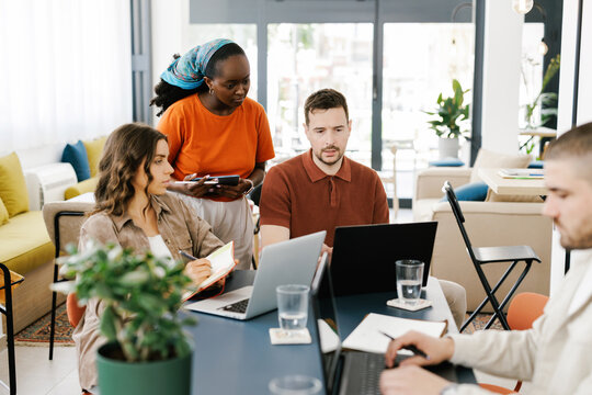 Team Members Collaborate in Modern Workspace During a Meeting