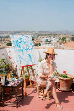 Portrait of artist at rooftop during painting process