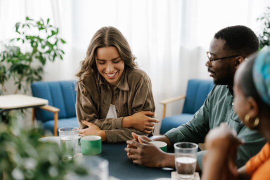 Friends Enjoy Drinks and Conversation in a Cafe Setting