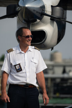 Pilot Walking in Front of Aircraft Propeller