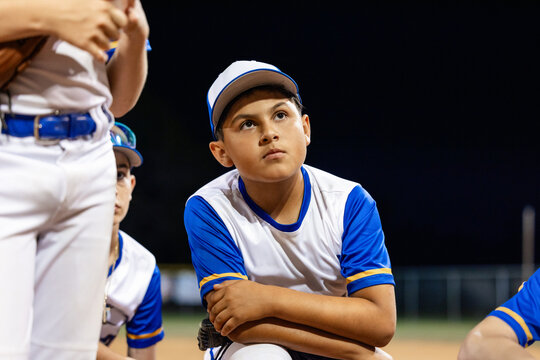 Young Team Focuses During Baseball Training at Night