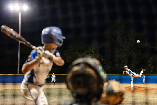 Young Team Trains at Night on Baseball Diamond
