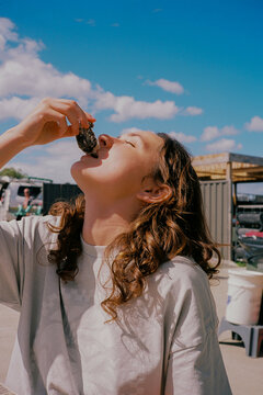 Woman eats a fresh oyster from its shell 