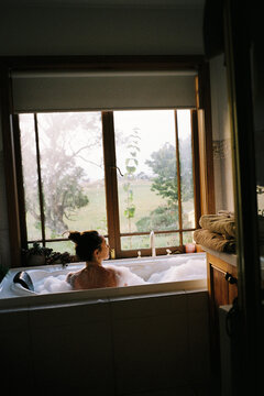 Woman in a bathtub with nice view, shot on film 