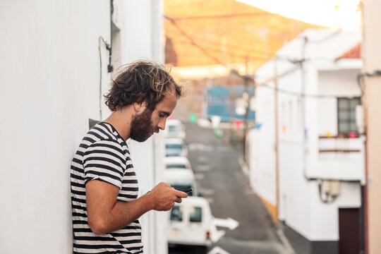 Young man using smartphone on urban street