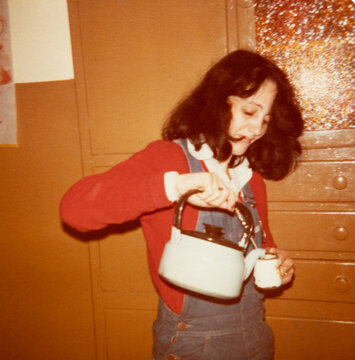 A woman serving mate in a 1970s kitchen