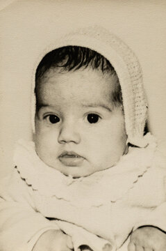 Baby wearing bonnet vintage portrait 1970s sepia