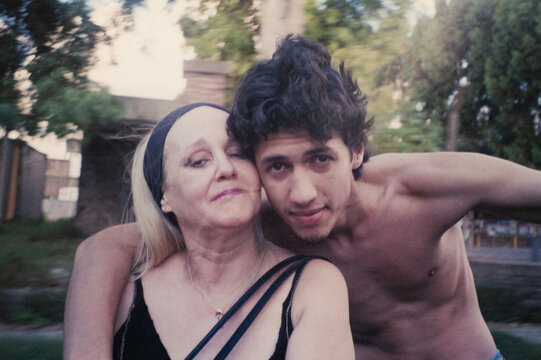 Mother and son embracing outdoors 1990s analogue style