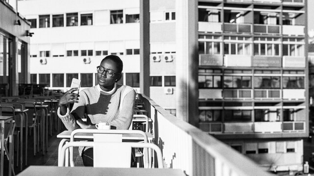 Person Checking Phone Outdoors
