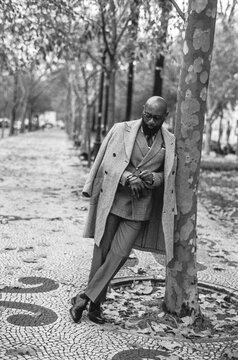 Man Leaning by Tree