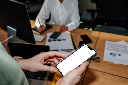 Close-up Smartphone with Blank Screen in Hands During Workday