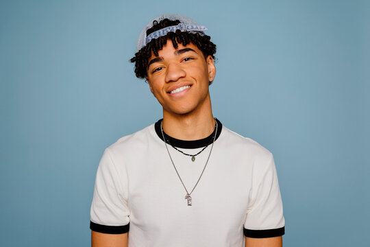 Man smiling against blue background with casual style