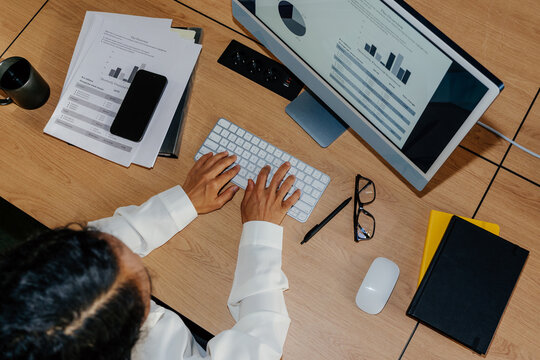 Top View Businesswoman Working at Desk With Financial Reports