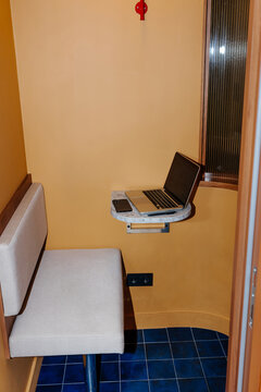 Private Office Booth Workspace with Laptop and Bench Seating